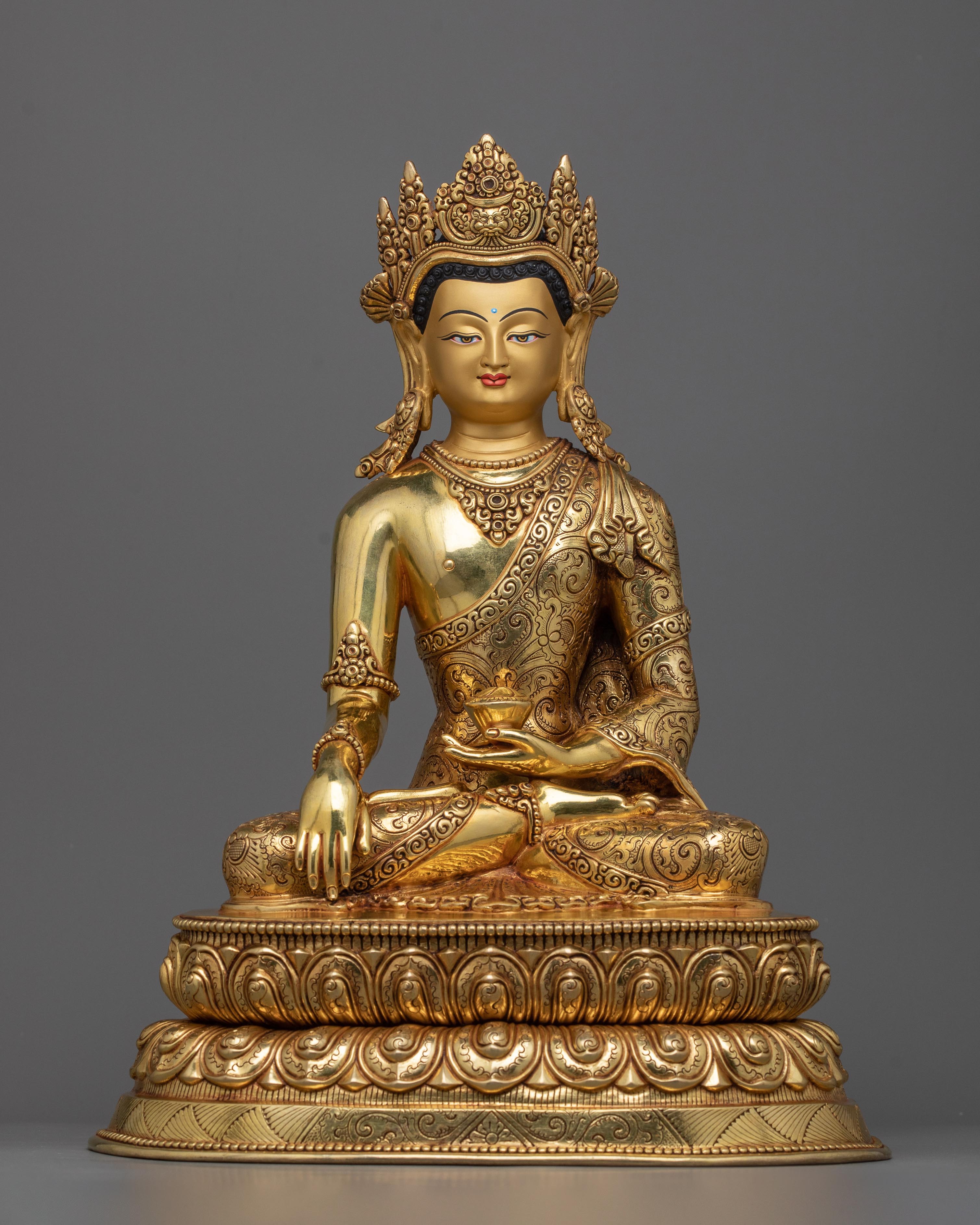 a golden buddha statue sitting on top of a table