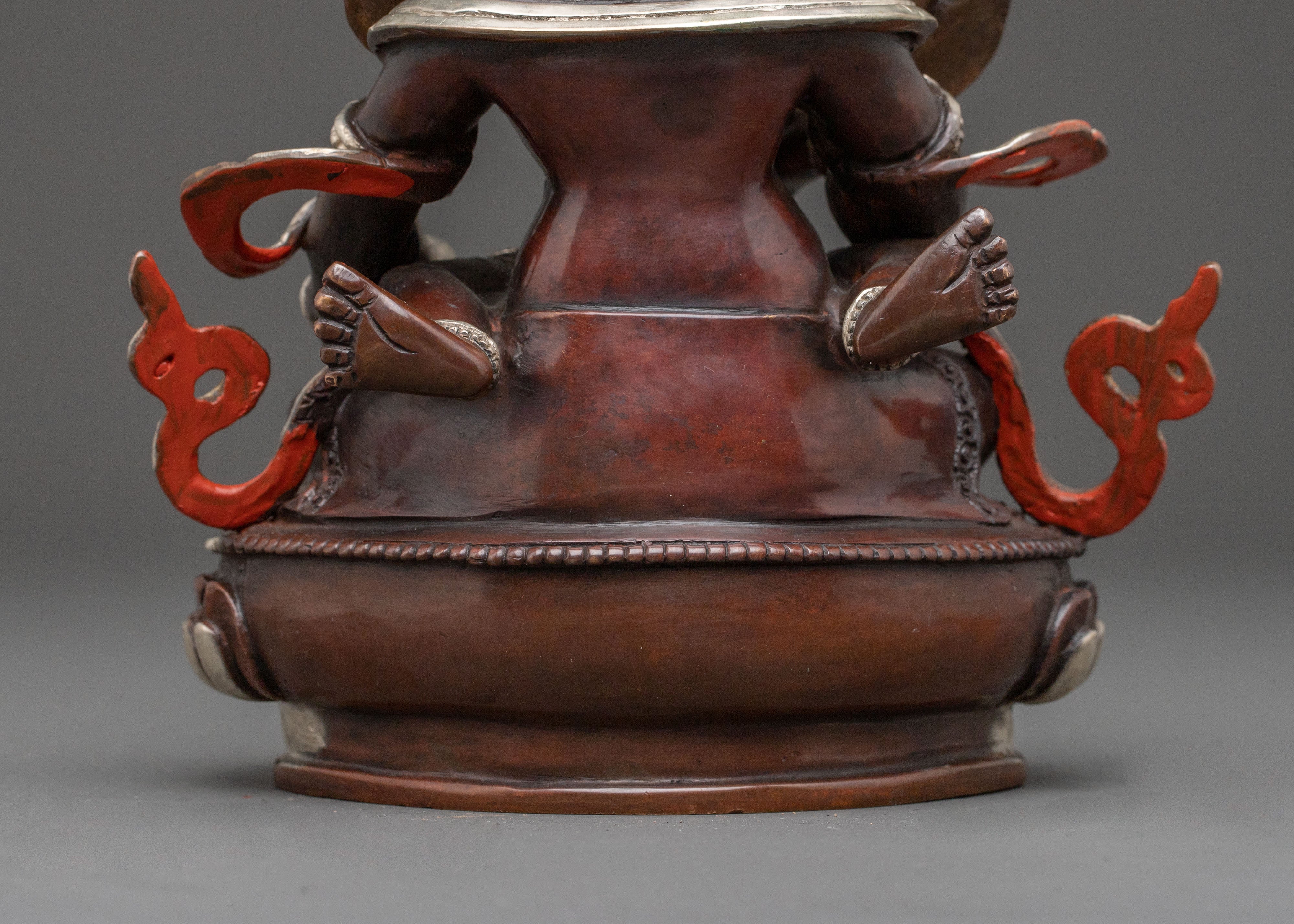 Handcrafted Statue of Red Dzambhala: Oxidized Copper Form
