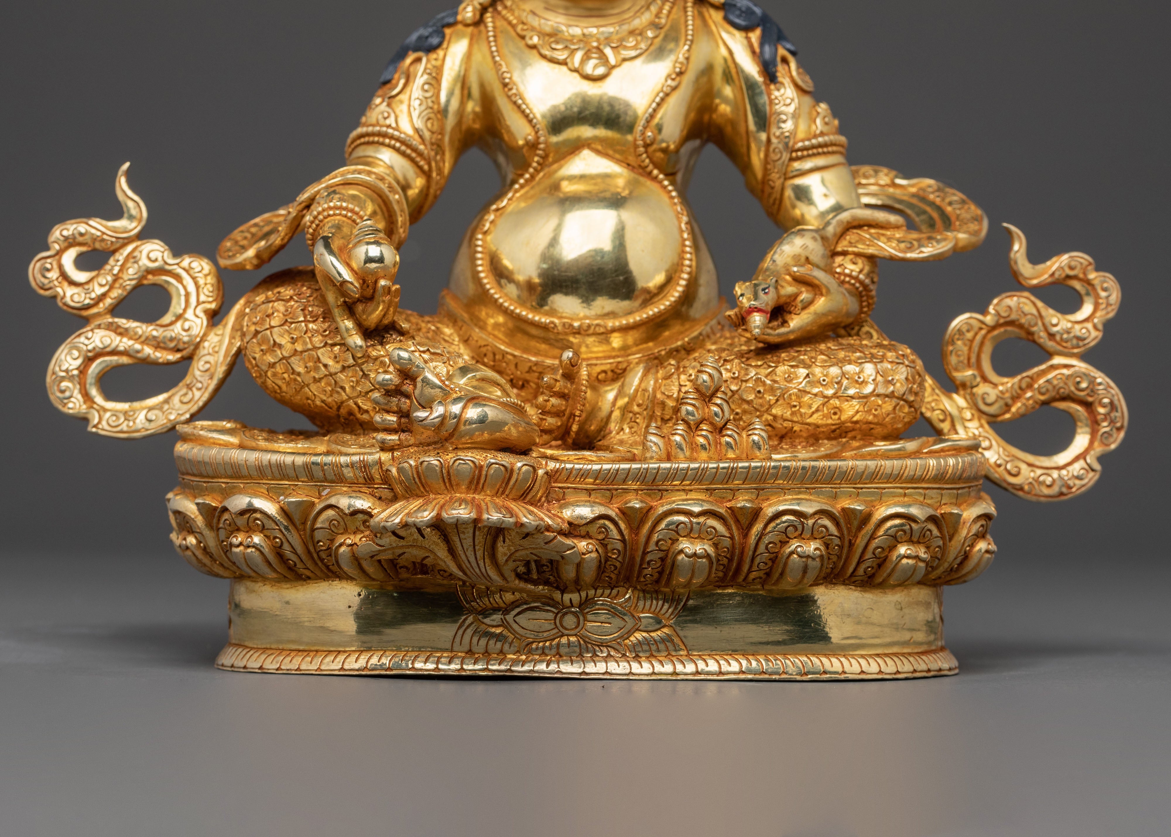 Golden Dzambhala Statue: Embodiment of Generosity